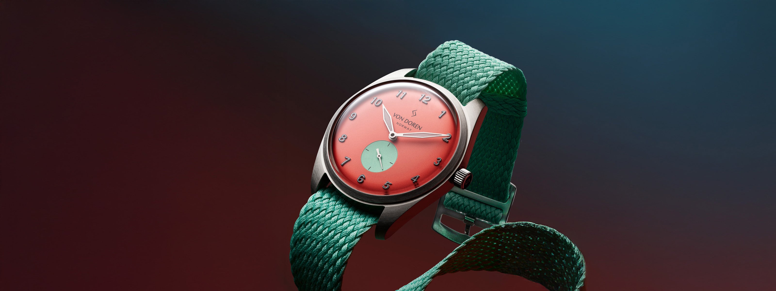 Von Doren Runde Candy Chili watch with red dial and green perlon strap against a colorful gradient background.