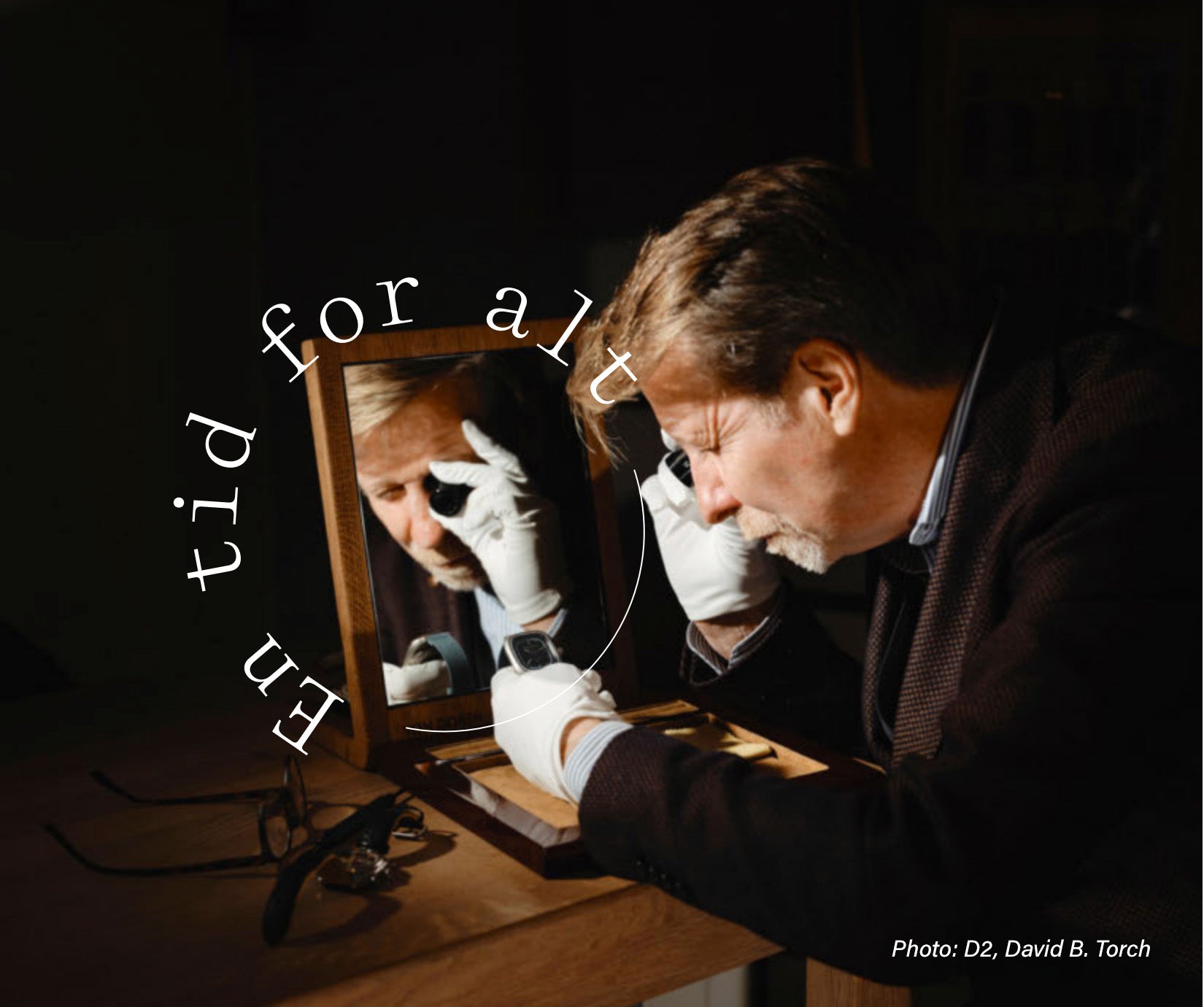 Man inspecting a watch with white gloves, reflected in a mirror under warm light.