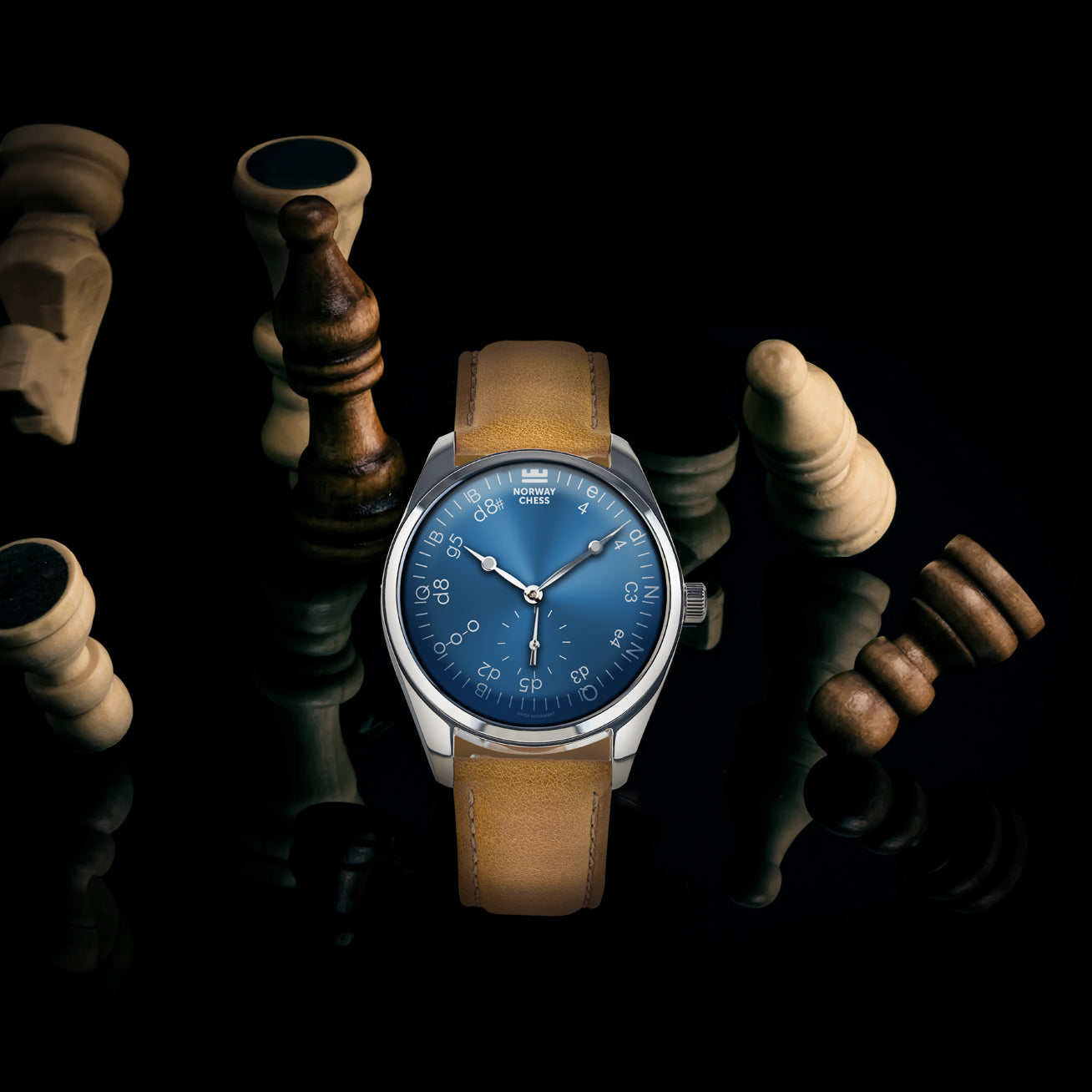 Norway Chess Réti Mark II Blue watch displayed among scattered chess pieces on a dark surface.